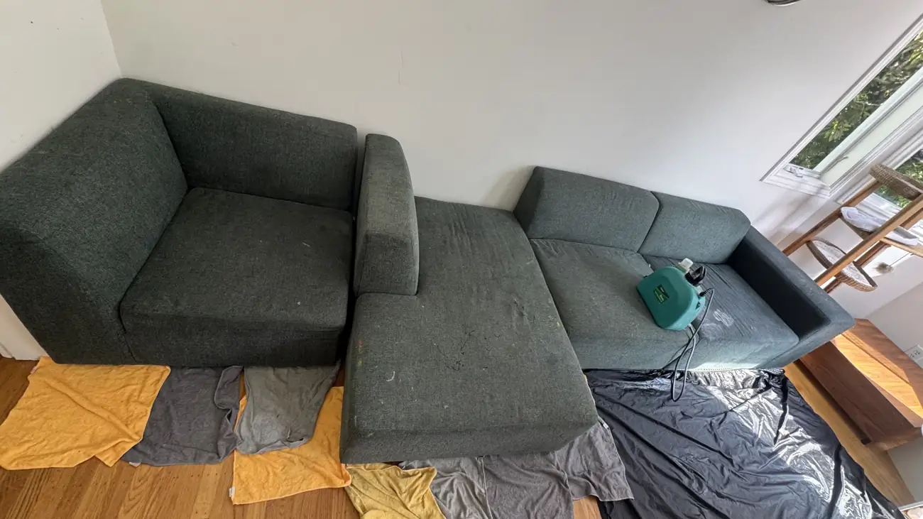 Charcoal modular sectional and chaise prepared for deep cleaning