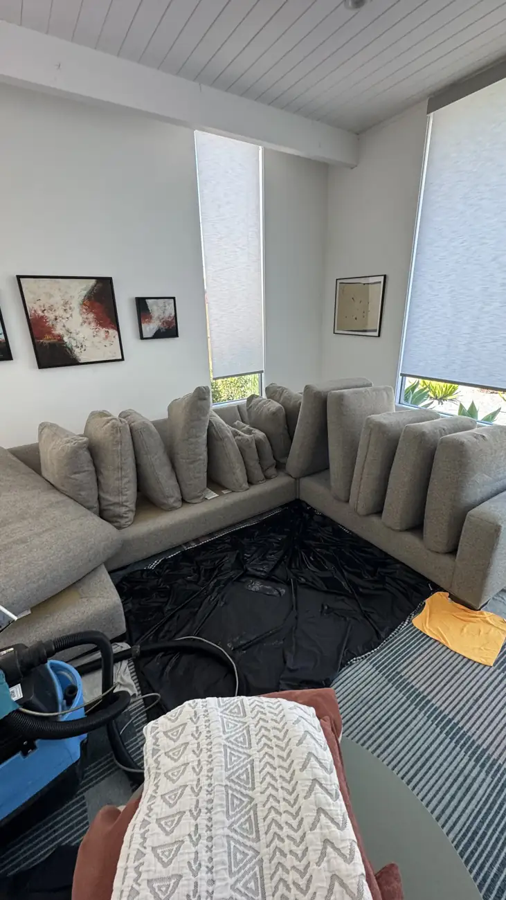 Sectional cushions removed and floor protected during deep cleaning in San Francisco