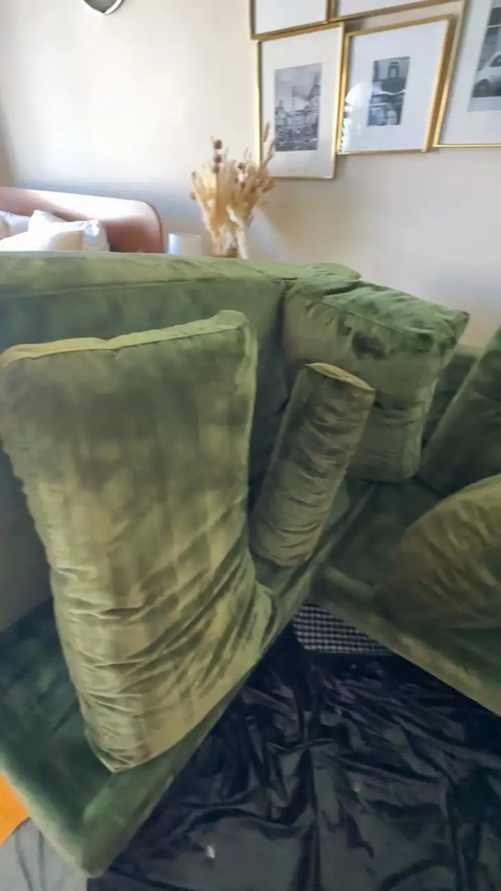 Green velvet cushions after cleaning, deep saturated color restored and drying