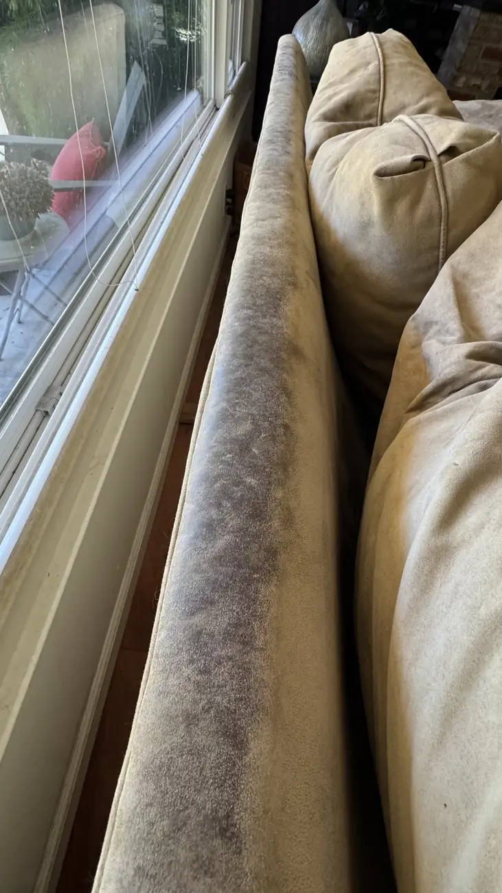 Long bolster cushion before cleaning with dark soiled edges