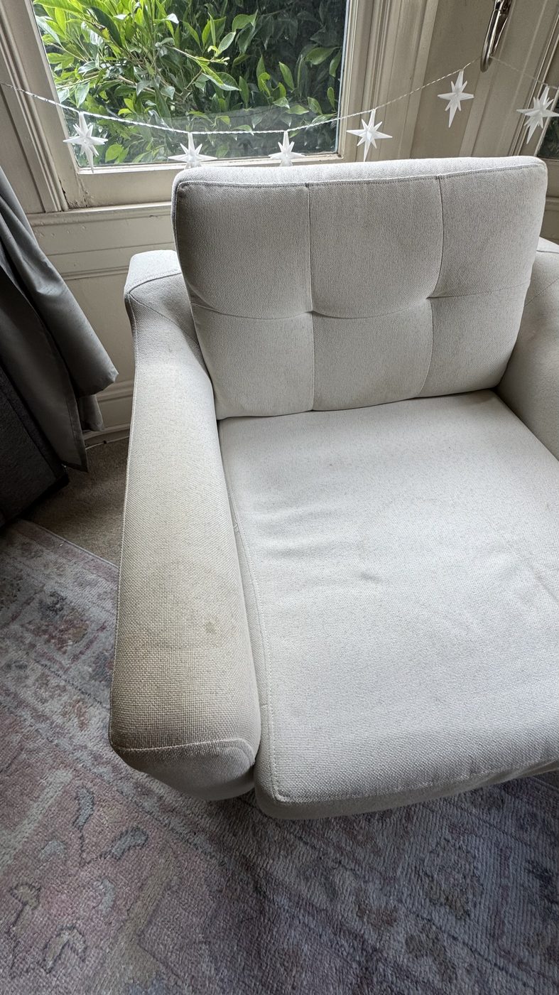 Light armchair before cleaning, soiled seat and salt deposits