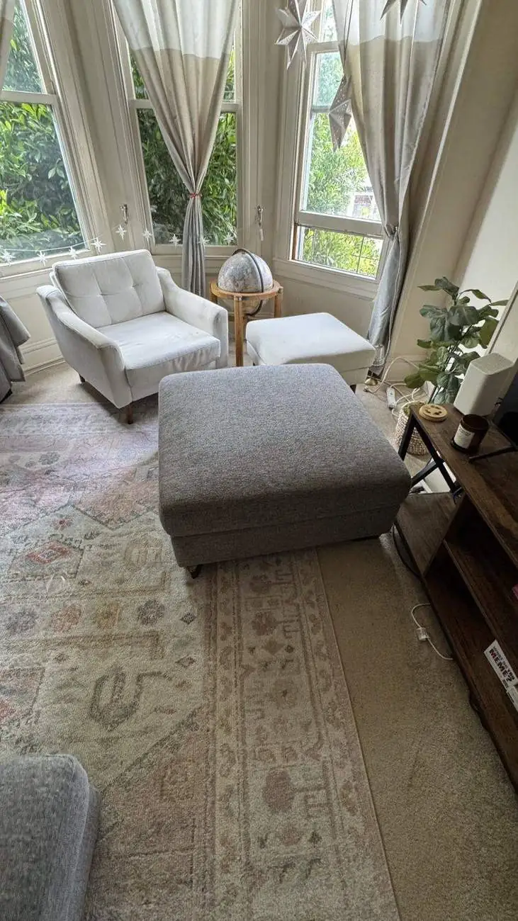 Light armchair and ottoman after professional cleaning in San Francisco