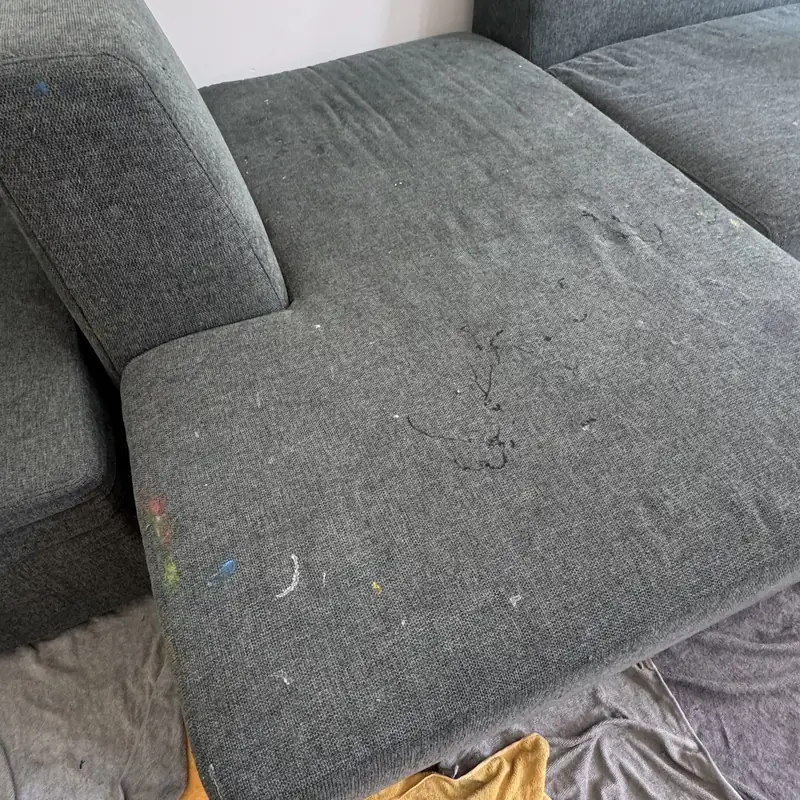 Close-up of the charcoal sectional seat during extraction cleaning