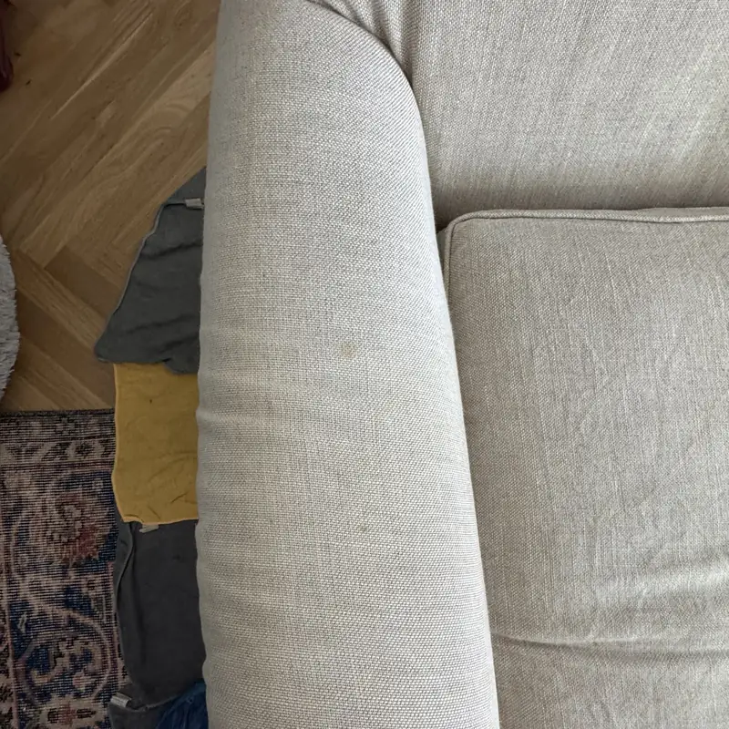 Close-up of cream sofa upholstery during deep cleaning