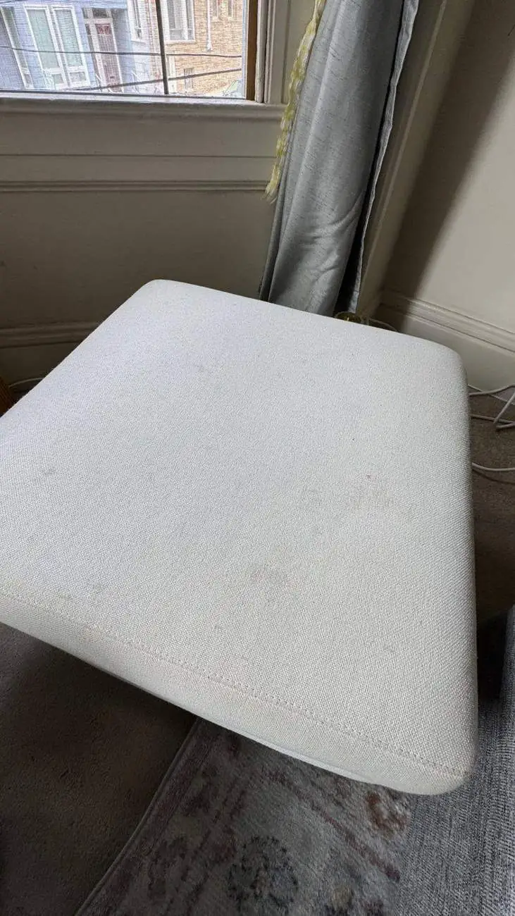 Light ottoman after deep cleaning in a San Francisco apartment