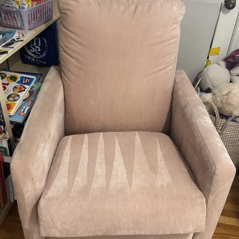 Pink upholstered armchair after cleaning with the pile lifted